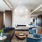 bronze table with with blue end chairs and grey sofa